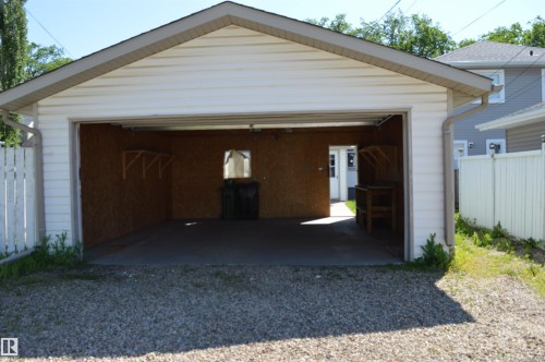 Detached two-car garage with white vinyl siding and an asphalt shingle roof - 11920 78 Street, Edmonton, AB 