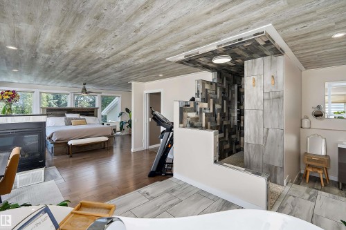 Open concept room with wood-finish flooring and a wood-panel ceiling - 4 Wentworth Crescent, St. Albert, AB 