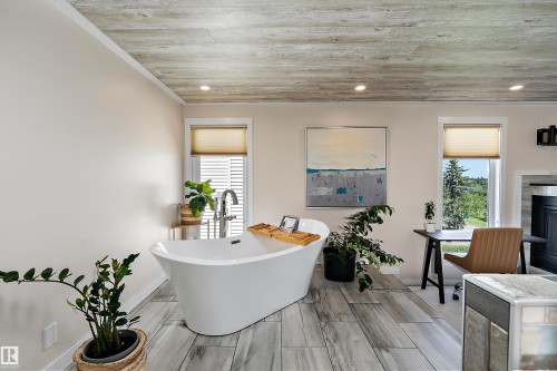 Freestanding soaking tub with chrome fixtures, wood-finish flooring, and recessed ceiling lighting - 4 Wentworth Crescent, St. Albert, AB 