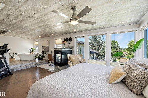 Expansive room featuring wood-finish flooring, a wood-paneled ceiling, and a contemporary ceiling fan - 4 Wentworth Crescent, St. Albert, AB 