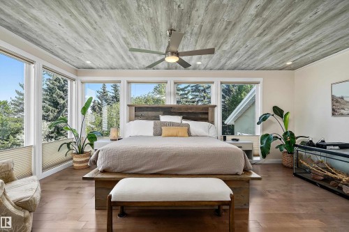 Spacious bedroom featuring wood-finish flooring and a distinctive wood-plank ceiling - 4 Wentworth Crescent, St. Albert, AB 