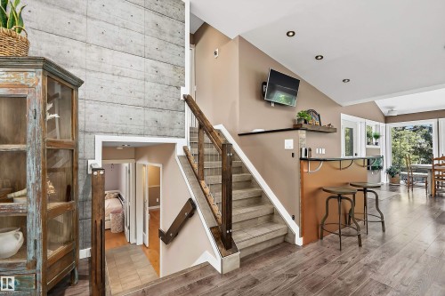 Board-formed concrete accent wall with wood-finish flooring - 4 Wentworth Crescent, St. Albert, AB 