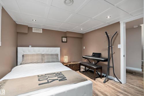 Room featuring wood-finish flooring, recessed lighting, and a white paneled ceiling - 4 Wentworth Crescent, St. Albert, AB 