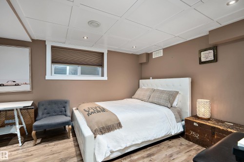 Room featuring wood-finish flooring, recessed lighting, and a window with a cellular shade - 4 Wentworth Crescent, St. Albert, AB 