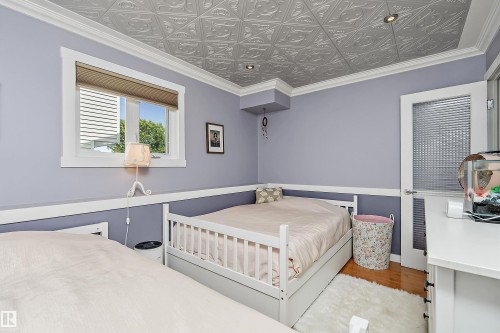 Recessed lighting illuminates a patterned ceiling with crown molding - 4 Wentworth Crescent, St. Albert, AB 