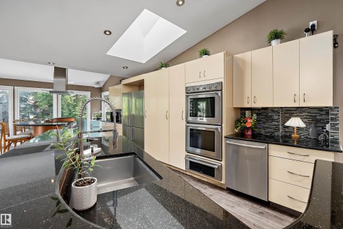 Kitchen featuring a large skylight, recessed lighting, and a vaulted ceiling - 4 Wentworth Crescent, St. Albert, AB 