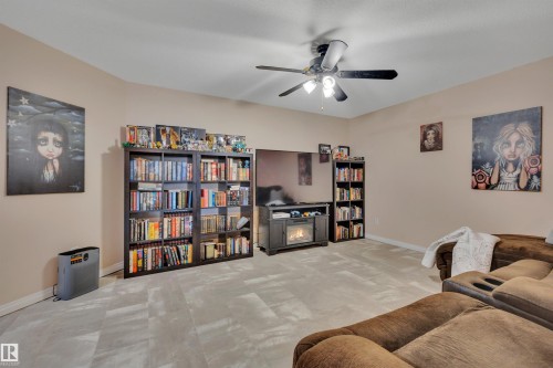 Spacious room featuring neutral wall tones, multi-tone tile flooring, and a ceiling fan with integrated lighting - #47 2505 42 St Nw, Edmonton, AB 