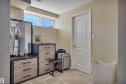 Recessed windows with natural light, light neutral wall paint, and a classic white door with chrome hardware - 
