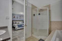 Bathroom featuring a corner shower enclosure, a bathtub, and a vanity with a countertop and undermount sink - 