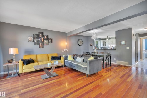 Living area featuring wood-finish flooring, grey painted walls, and a recessed ceiling - #47 2505 42 St Nw, Edmonton, AB 
