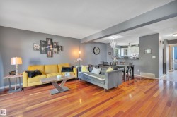 Living area featuring wood-finish flooring, grey painted walls, and a recessed ceiling - 