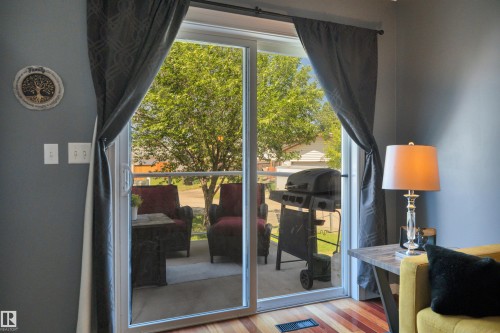 Sliding glass door opening to an outdoor patio space - #47 2505 42 St Nw, Edmonton, AB 