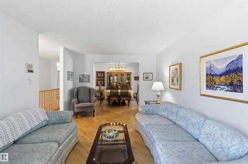 Hardwood-style flooring throughout the primary living area and dining space - 31 Gariepy Crescent, Edmonton, AB 