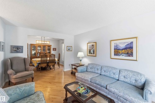 Bright living space featuring light-toned walls and wood-finish flooring - 31 Gariepy Crescent, Edmonton, AB 