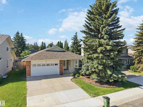Single-story residence featuring a two-car garage, brick facade accents, and a front bay window - 31 Gariepy Crescent, Edmonton, AB 
