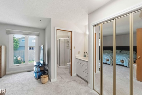 Light grey carpeting throughout with a window featuring a white frame and window treatment - 31 Gariepy Crescent, Edmonton, AB 