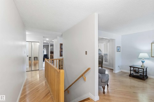 Hardwood flooring featured throughout the hallway and living area - 31 Gariepy Crescent, Edmonton, AB 
