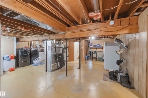 Unfinished basement featuring exposed wood joists and concrete flooring - 31 Gariepy Crescent, Edmonton, AB 