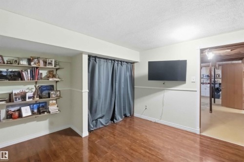 Finished lower level featuring wood-finish flooring, wainscoting, and built-in shelving - 31 Gariepy Crescent, Edmonton, AB 