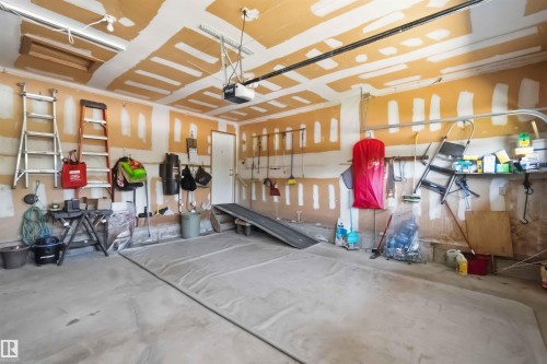 Concrete flooring with exposed drywall and ceiling joists - 31 Gariepy Crescent, Edmonton, AB 