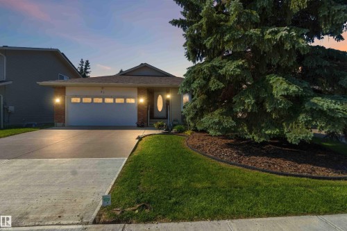 Single-story residence featuring a front entry garage, concrete driveway, and brick accent siding - 31 Gariepy Crescent, Edmonton, AB 