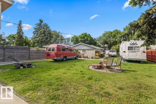 Spacious yard featuring a circular paver patio with a central fire pit - 4622 Ada Boulevard, Edmonton, AB 