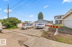 Concrete driveway leading to a single-car garage with light blue siding - 