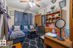 Room featuring wood-finish flooring, a ceiling fan with integrated lighting, and a built-in shelving unit - 