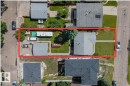 Property featuring a detached garage, a paved driveway, and a front lawn with a concrete walkway - 4622 Ada Boulevard, Edmonton, AB 