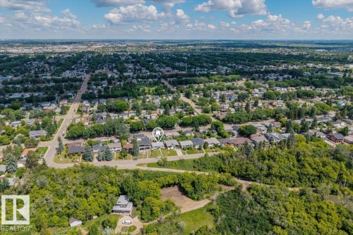 Aerial perspective of a residential neighborhood featuring established homes and abundant tree cover - 4622 Ada Boulevard, Edmonton, AB 