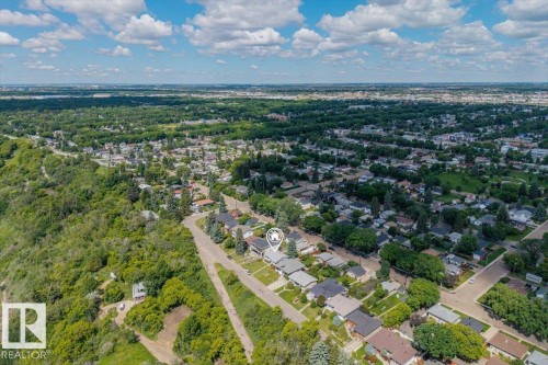 Aerial perspective showcasing a residential neighborhood with extensive green spaces and mature tree canopies - 4622 Ada Boulevard, Edmonton, AB 