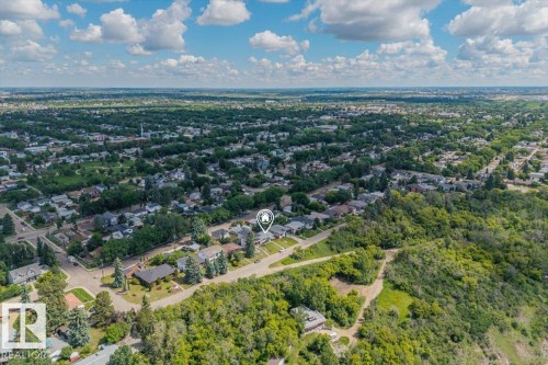 Aerial perspective showcasing a residential area bordered by dense green spaces - 4622 Ada Boulevard, Edmonton, AB 