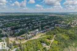 Aerial perspective showcasing a residential area bordered by dense green spaces - 
