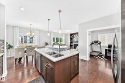Kitchen island featuring a double-basin sink and an integrated dishwasher - 