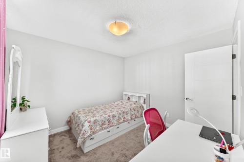 Bright interior space featuring light gray walls and a textured ceiling - 3672 Claxton Place, Edmonton, AB 