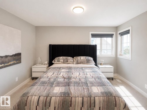 Neutral-toned bedroom featuring wall-to-wall carpeting and white baseboards - 1004 Huckell Pl Sw, Edmonton, AB - Indoor Photo Showing Bedroom