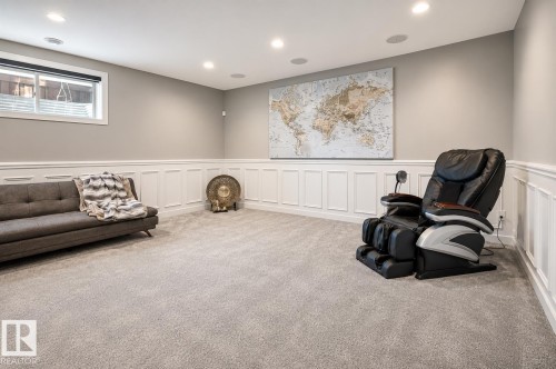 Spacious room with light gray wall paint and white wainscoting - 1004 Huckell Pl Sw, Edmonton, AB - Indoor