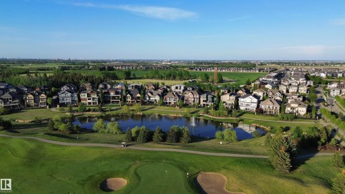 Residential properties bordering a golf course with a central pond - 1004 Huckell Pl Sw, Edmonton, AB - Outdoor With View