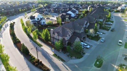 Suburban street with residential properties featuring varied architectural styles and mature landscaping - 1004 Huckell Pl Sw, Edmonton, AB - Outdoor With View