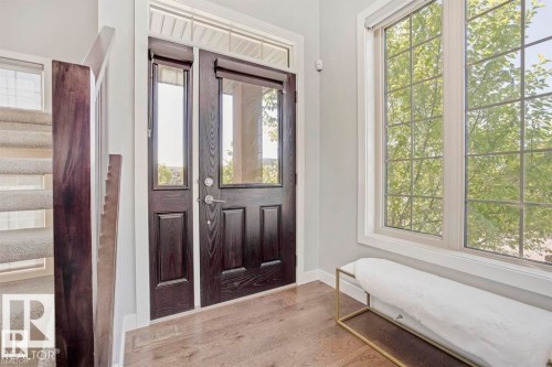 Entryway featuring a dark wood-finish door with glass panels and a transom window - 1004 Huckell Pl Sw, Edmonton, AB - Indoor Photo Showing Other Room