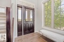 Entryway featuring a dark wood-finish door with glass panels and a transom window - 1004 Huckell Pl Sw, Edmonton, AB  - Indoor Photo Showing Other Room 