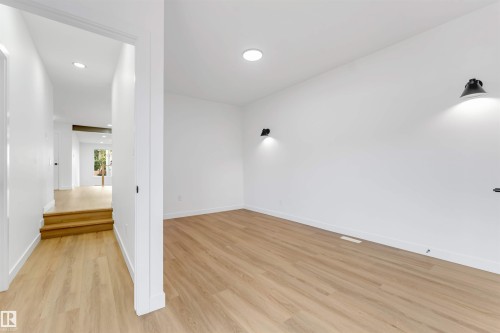 Bright interior featuring light wood-finish flooring and recessed ceiling lighting - 5512 150 Avenue, Edmonton, AB 