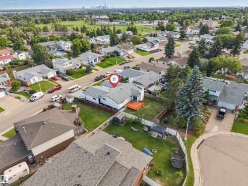 Aerial view of a residential property with a light grey shingle roof and a spacious backyard - 5512 150 Avenue, Edmonton, AB 