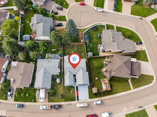 Aerial view of a residential property featuring a gray shingle roof and a paved driveway - 5512 150 Avenue, Edmonton, AB 