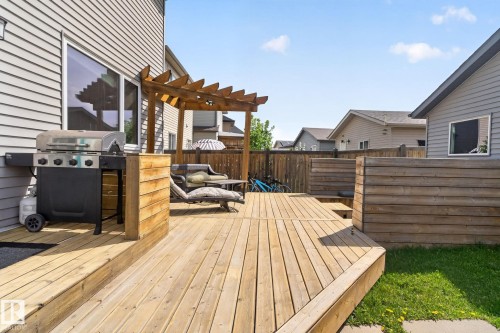 Multi-level wood deck featuring a pergola, wood privacy screening, and a sliding glass door entry - 3456 Cutler Crescent, Edmonton, AB - Outdoor With Deck Patio Veranda With Exterior