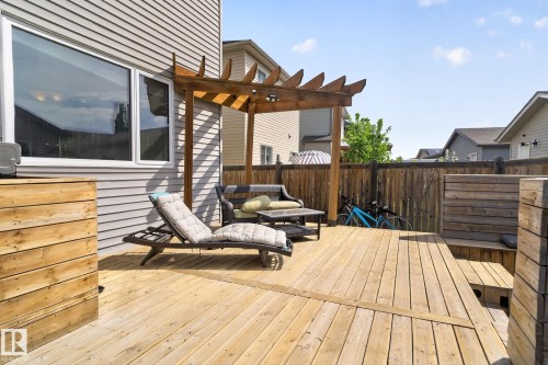 Spacious wood-plank deck featuring a built-in pergola, privacy fencing, and integrated wood planters - 3456 Cutler Crescent, Edmonton, AB - Outdoor With Deck Patio Veranda With Exterior