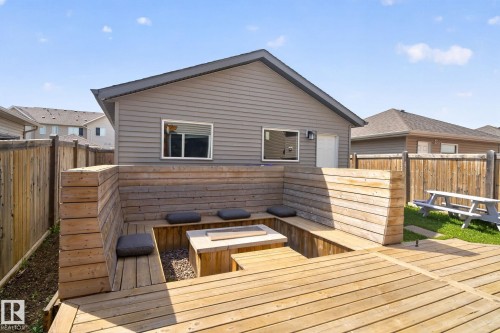 Backyard featuring an expansive wood-finish deck with built-in bench seating - 3456 Cutler Crescent, Edmonton, AB - Outdoor With Deck Patio Veranda With Exterior
