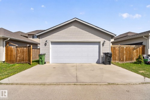 Detached garage featuring panel siding and a sectional overhead door - 3456 Cutler Crescent, Edmonton, AB - Outdoor With Exterior