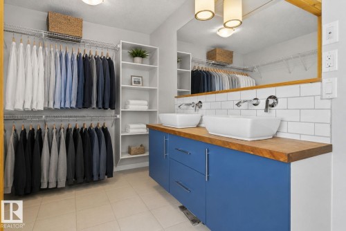 Custom closet system with white shelving and chrome hanging rods - 3456 Cutler Crescent, Edmonton, AB - Indoor Photo Showing Other Room