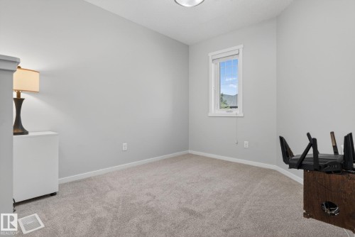 Light gray carpeting and painted walls establish a neutral palette - 3456 Cutler Crescent, Edmonton, AB - Indoor Photo Showing Other Room